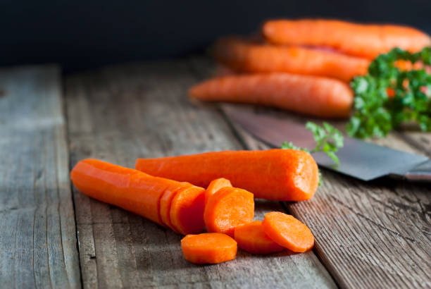 istock Cooking process, cutting carrot on table, closeup. Healthy food. 1056225900