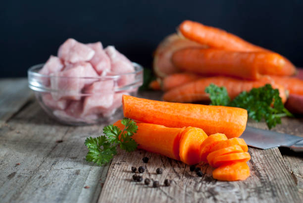 Cooking process, cutting carrot on table, closeup. Healthy food.
