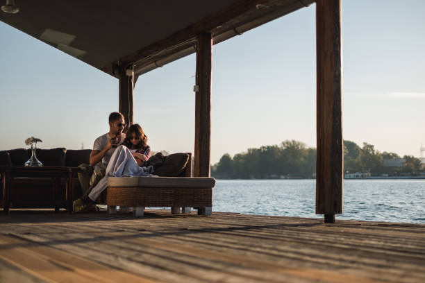 istock Couple not talking sitting by the river in sunset 1056226992