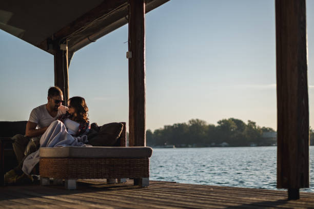 istock Serious couple hugging by the river in sunset 1056227006
