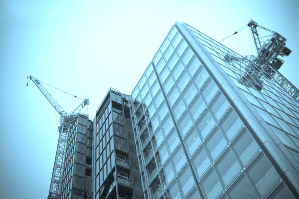 Window cleaning crane of an high rise glass curtain wall building - top of an office building with crane for the gondolas used by window washers and steeplejack - building façade hygiene and maintenance, facade access system. Cradle lift (roof trolley). Building Maintenance Unit (BMU).