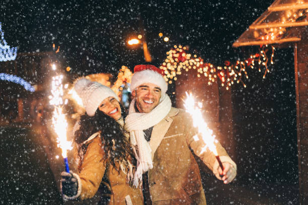 istock Young couple having fun with sparkling candles at night 1056235018