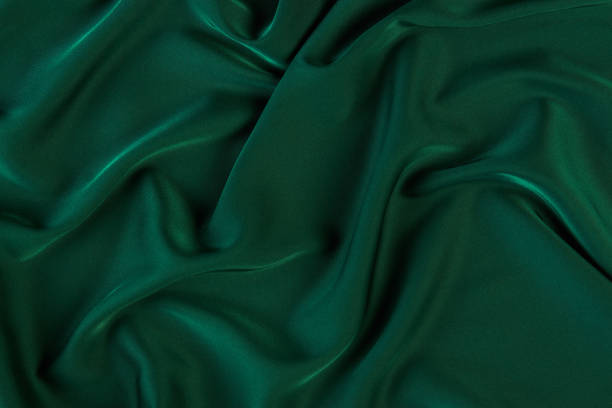 istock Green silk fabric background, view from above 1056236008