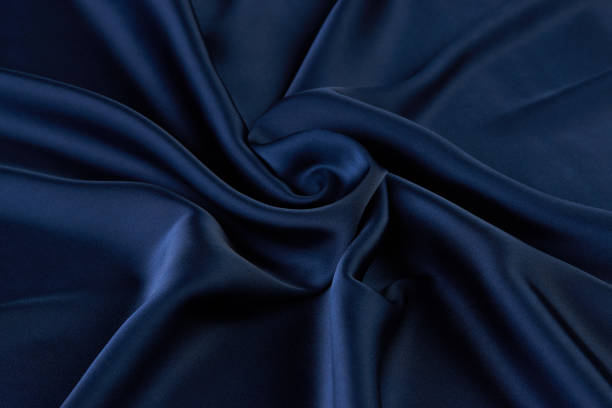 istock Dark blue silk fabric background, view from above 1056236024