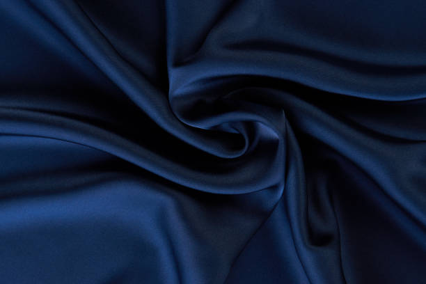 istock Dark blue silk fabric background, view from above 1056236028