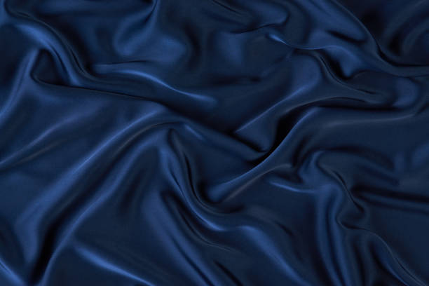 istock Dark blue silk fabric background, view from above 1056236038