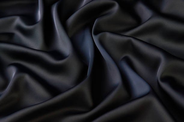 istock Black silk fabric background, view from above 1056236044