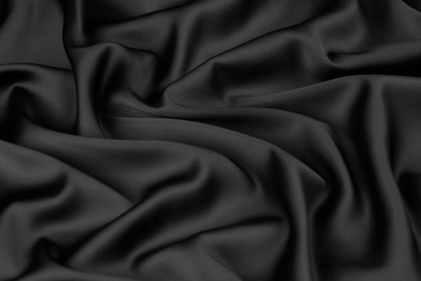 istock Black silk fabric background, view from above 1056236046