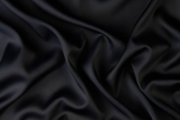 istock Black silk fabric background, view from above 1056236070
