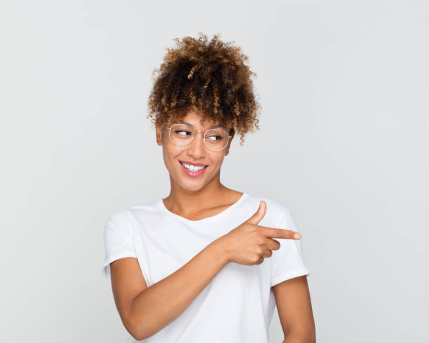 istock Beautiful african woman pointing away 1056239238
