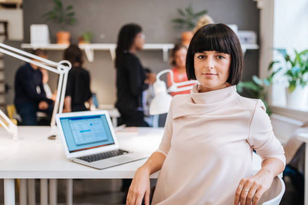 istock Beautiful determined businesswoman working in shared office 1056239386