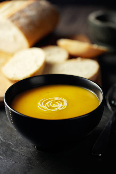 healthy spicy pumpkin soup with sour cream - dieting front view vertical lifestyles imagens e fotografias de stock