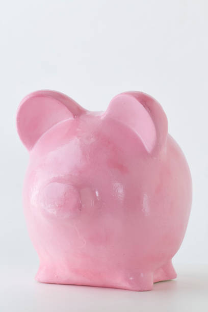 istock Pink piggy bank saving money on white background 1056241930
