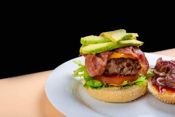 istock Bacon, cheese and avocado burger on a bread bun 1056244772