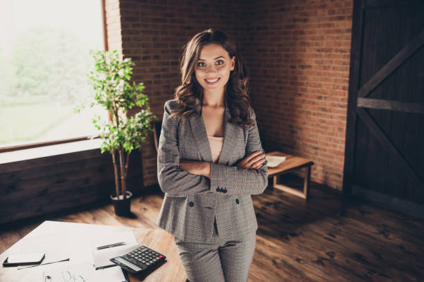 istock Cheerful glad adorable elegant stylish beautiful classic trendy business shark, lady in grey jacket, suit with crossed folded arms at work place, station 1056247708