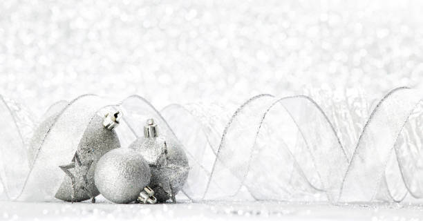 istock Silver christmas balls and stars on silver glitter background 1056248212