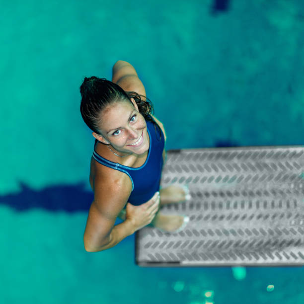 istock Female diver standing on the jumping board. 1056251012