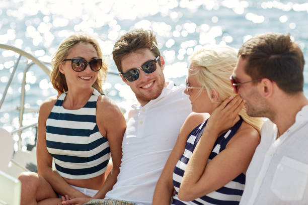 istock smiling friends sitting on yacht deck 1056253374