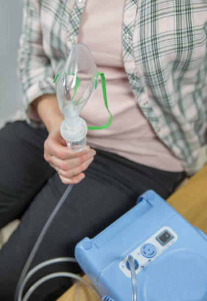 istock Patient holds a nebuliser in a surgery hospital 1056254408