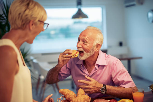 istock Happy smiling senior couple having breakfast 1056254602