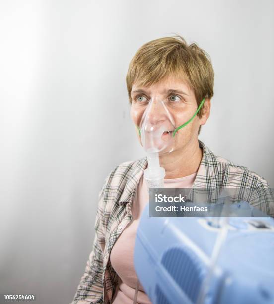 Patient Tries On A Nebuliser In A Surgery Hospital Stock Photo - Download Image Now - Nebulizer, Nurse, Asthma Inhaler
