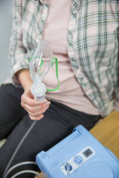 istock Patient holds a nebuliser in a surgery hospital 1056254680