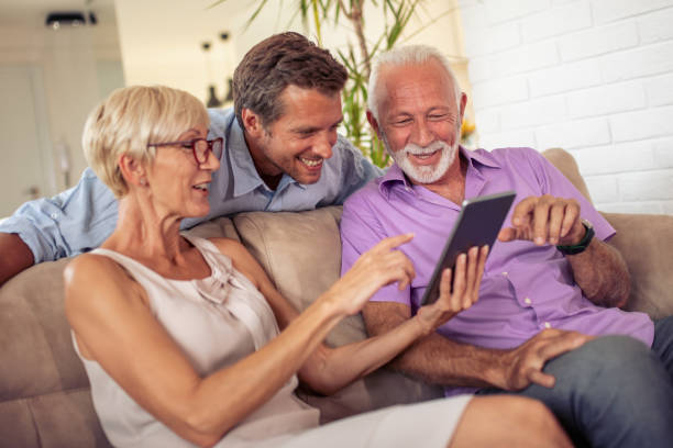 istock Senior couple with their son using digital tablet together 1056256102