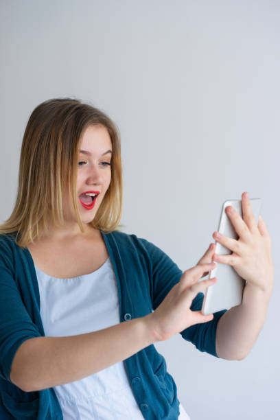 istock Surprised user excited with new mobile app 1056257432