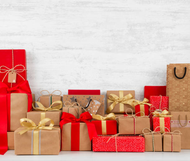 istock Christmas Gift Boxes on White Wooden Table 1056257470