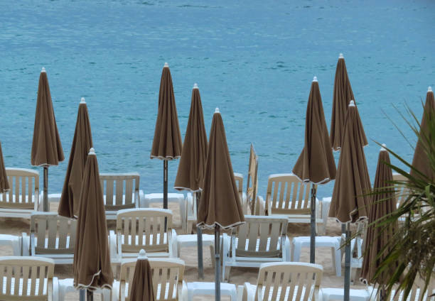 istock Cannes - Beige umbrellas on a beach 1056257482