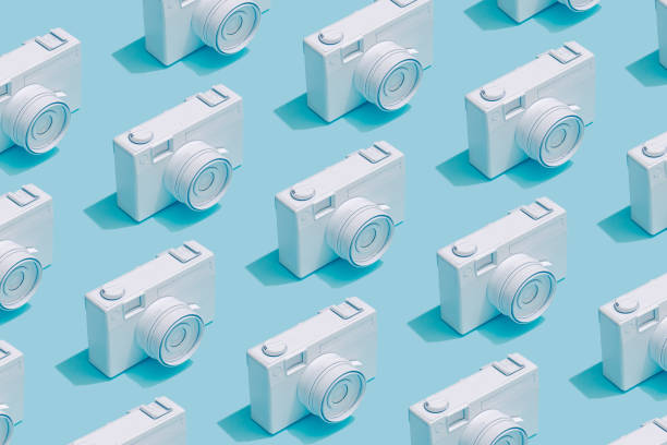 istock Pattern composition of vintage cameras on pastel blue background. 1056266080