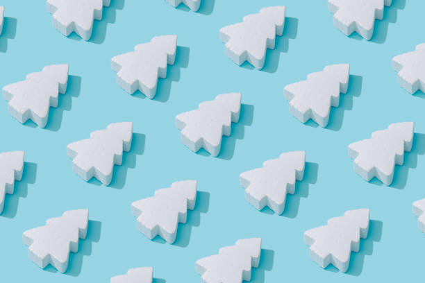 istock Pattern composition of white Christmas trees on pastel blue background. 1056266722
