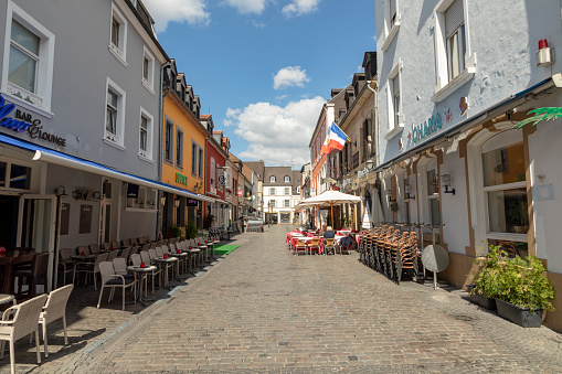 SAARLOUIS, GERMANY - AUG 26, 2018: street with restaurants and shops in old town of Saarlouis on midday.