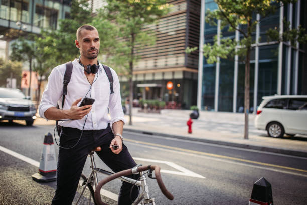 istock Man with headphones and mobile phone sitting on bicycle 1056267198