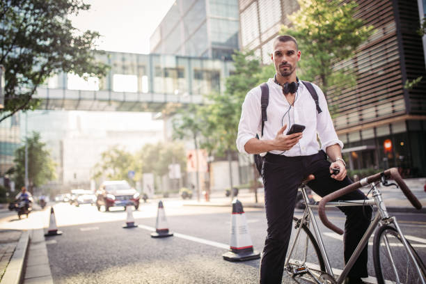 istock Man with headphones and phone sitting on bicycle 1056268460