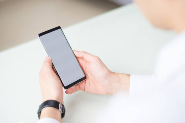 istock Close-up of businessman using modern smartphone 1056270140