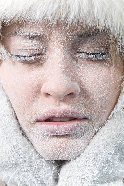 Very cold weather. Chilled female face covered in ice. Very cold weather. Close-up portrait of chilled female face covered in ice. frost face stock pictures, royalty-free photos & images