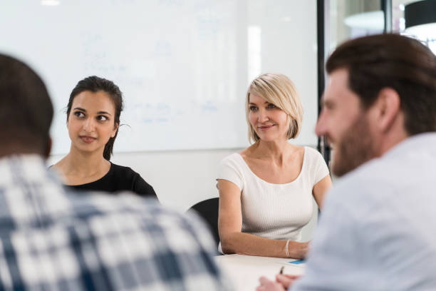 istock Multi-ethnic business team sitting in meeting 1056277620