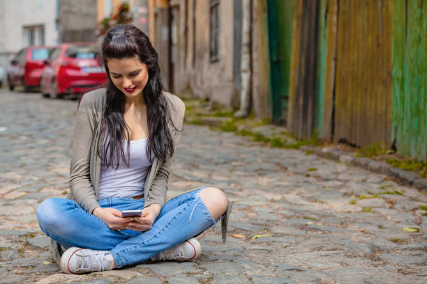 istock Cute young woman using cellphone in urban surroundings. 1056278562