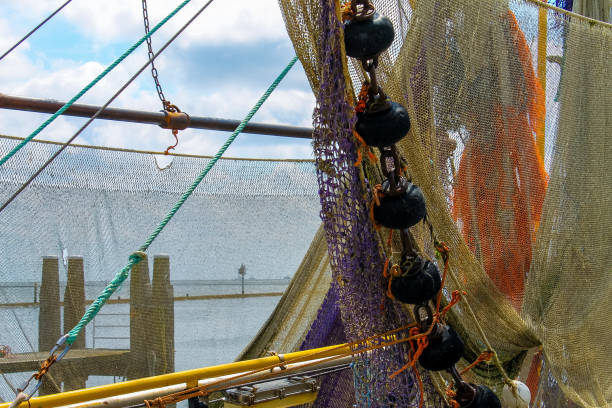 istock Fishing nets hanging on a boat. 1056278656