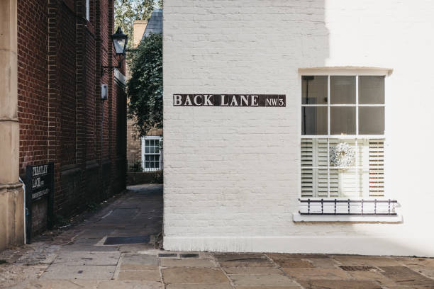 Street name sign on Back Lane, Hampstead, London, UK. Street name sign on a side of the building on Back Lane, Hampstead, London, UK. borough district type photos stock pictures, royalty-free photos & images