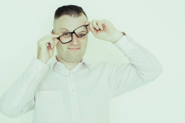 Crazy handsome businessman adjusting glasses and twisting it. Funny can not believing his eyes. Shocked news concept