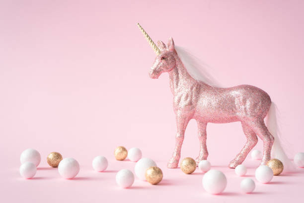 istock Pink glitter unicorn with gold and white decoration. 1056281476