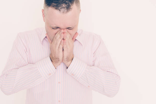 istock Wrinkly young businessman sneezing 1056281488