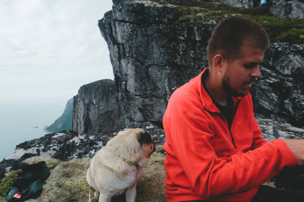 istock Man and dog flying drone at Norway mountains 1056285066