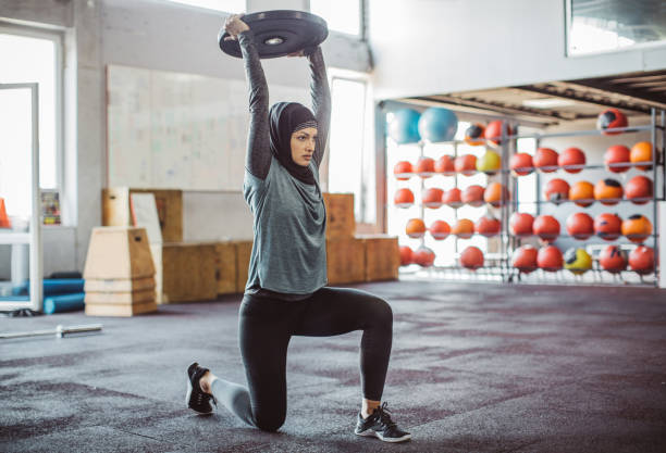 Motivated for success Young woman on cross training exercising. Wearing sports clothing and hijab. hijab stock pictures, royalty-free photos & images