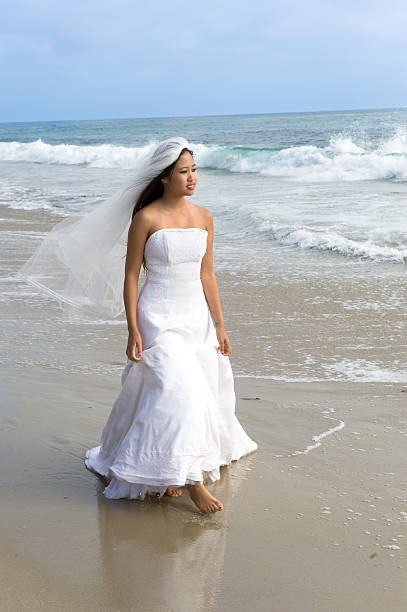 istock Asian bride in wedding dress at beach 105628732