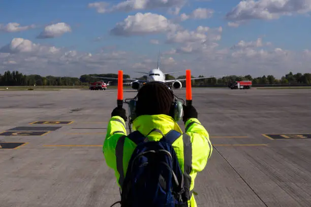 Photo of A supervisor helps at the aircraft parking