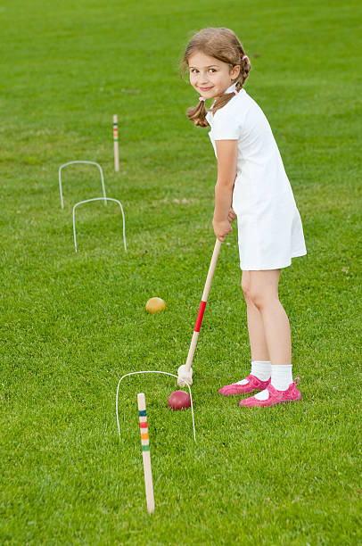 Little girl playing croquet stock photo