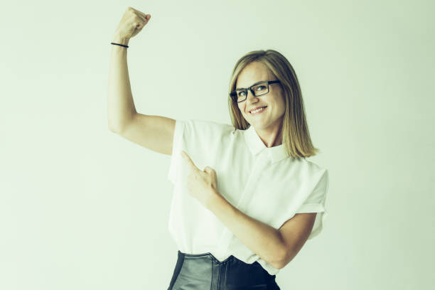 istock Smiling businesswoman or student showing muscles 1056292700